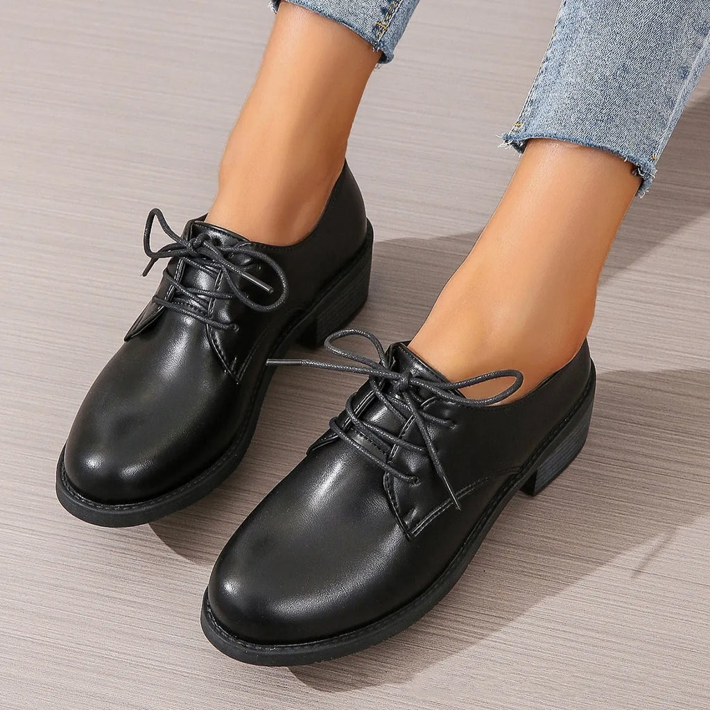 Black women's leather shoes with chunky heel, rubber sole, and low-top design for work and casual wear