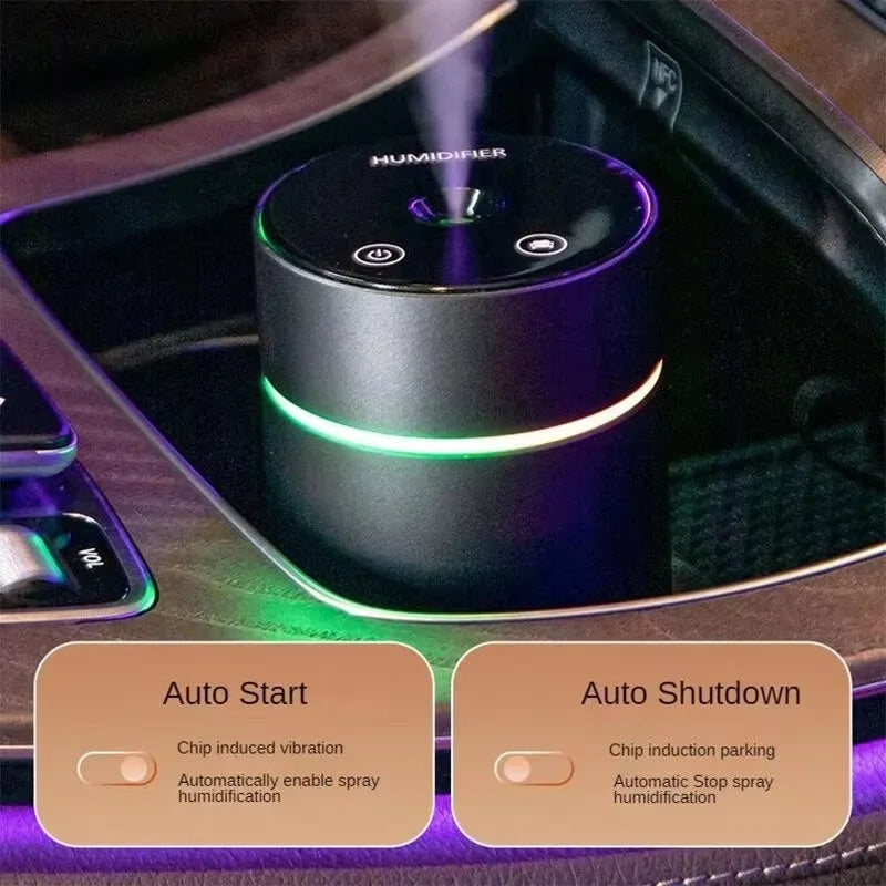 Compact aluminium car humidifier and essential oil diffuser with night light on a desk.