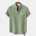 A loose-fit linen short-sleeve shirt with an ocean fish pattern, shown in a casual style.