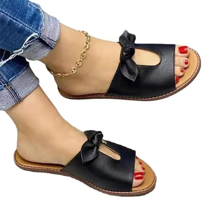 Ladies black sandals with bow detail and fish mouth open toe design on a white background