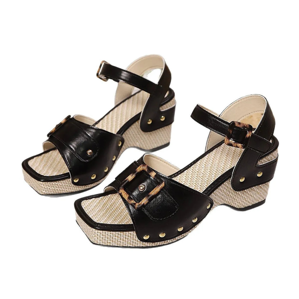 Women's black chunky heel sandals with a square toe and a metal buckle on the strap.