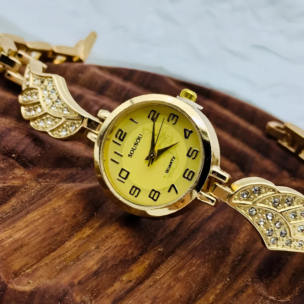 Women's stainless steel watch with round dial and vachette clasp, shown in gold colour.