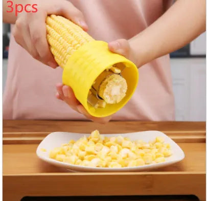 Yellow manual corn grinder thresher with corn-shaped PP handle and stainless steel gear.