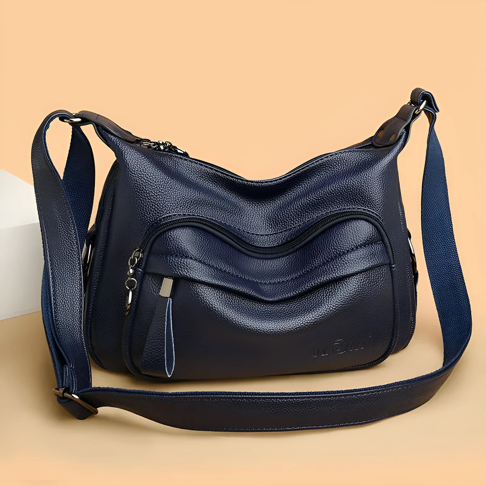 Large blue women's shoulder bag with multiple internal compartments and crossbody strap