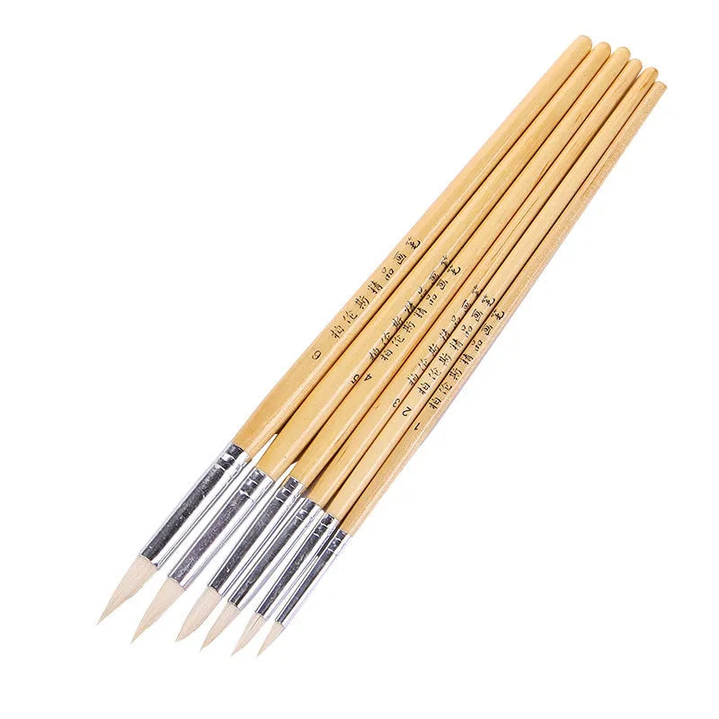 Six wooden-handled pointed hook line pen brushes with wool tips arranged together
