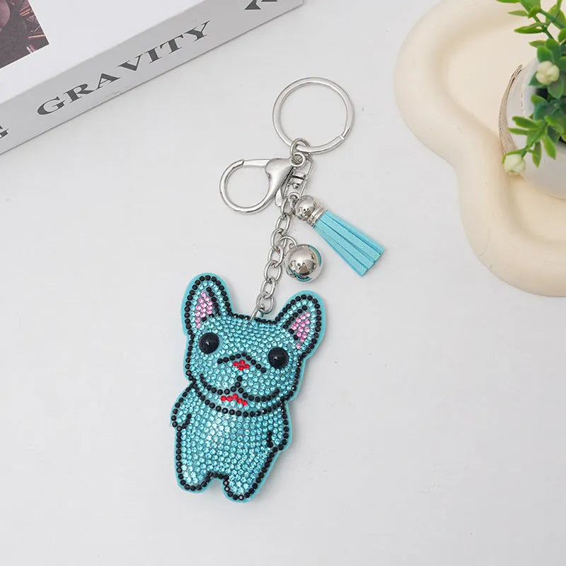 Close-up of a cartoon dog rhinestone keychain pendant on an alloy keyring