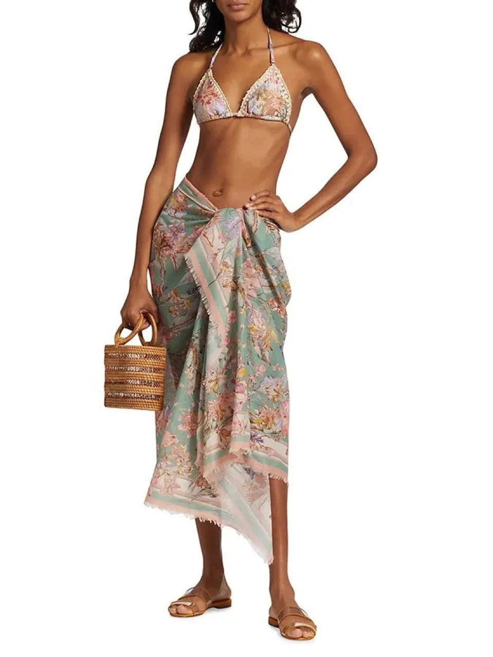 Women's creamy-white floral print bikini set with top, briefs, and skirt laid flat.