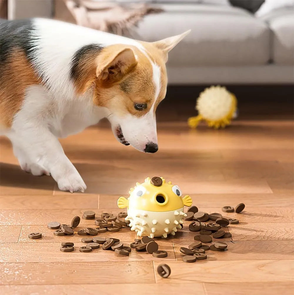 Green fish-shaped dog toy with squeaky bell and treat-dispensing opening
