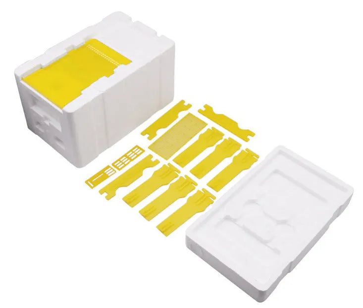 Three white EPS foam mini delivery boxes for bee mating and breeding arranged on a flat surface