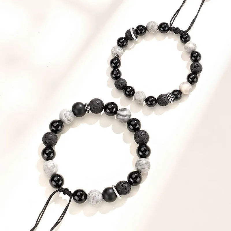 Black agate map stone diamond-shaped volcanic rock bracelet on a wrist, showing New Chinese style.