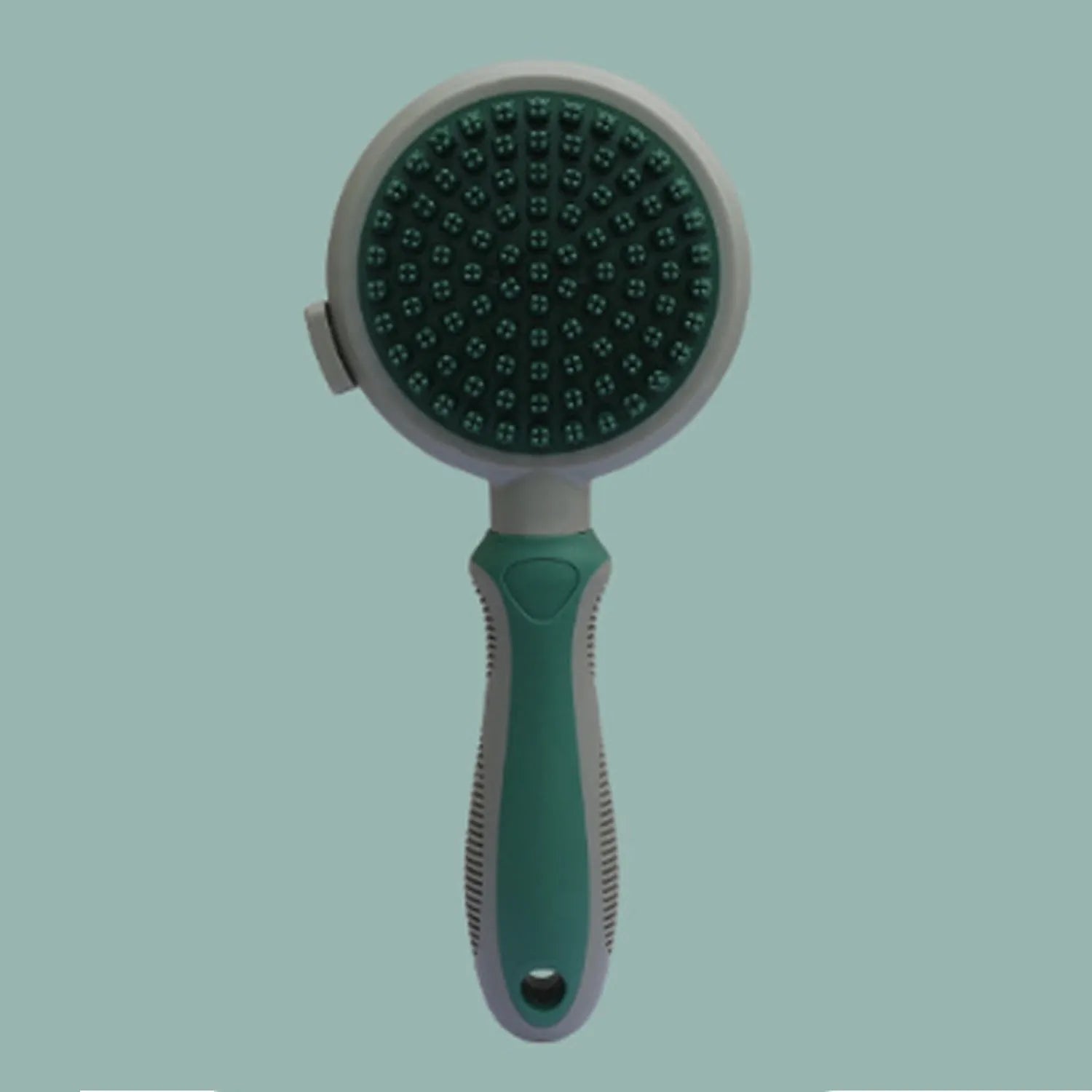 Pink and green double-sided cat brush with release button and attached flea comb