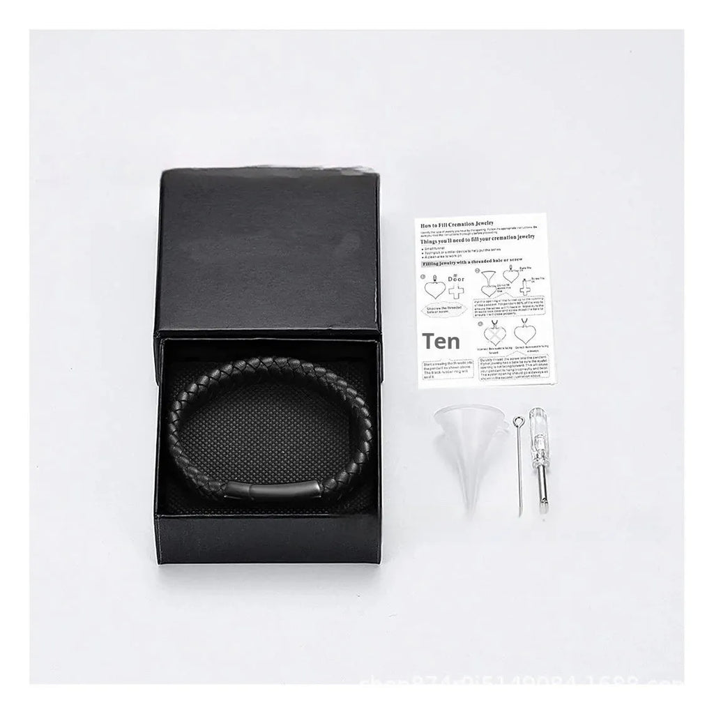 Black leather cord bracelet with woven stainless steel casket pendant.