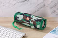 Fabric-covered portable Bluetooth speaker with card holder slots, shown in multiple colour options.