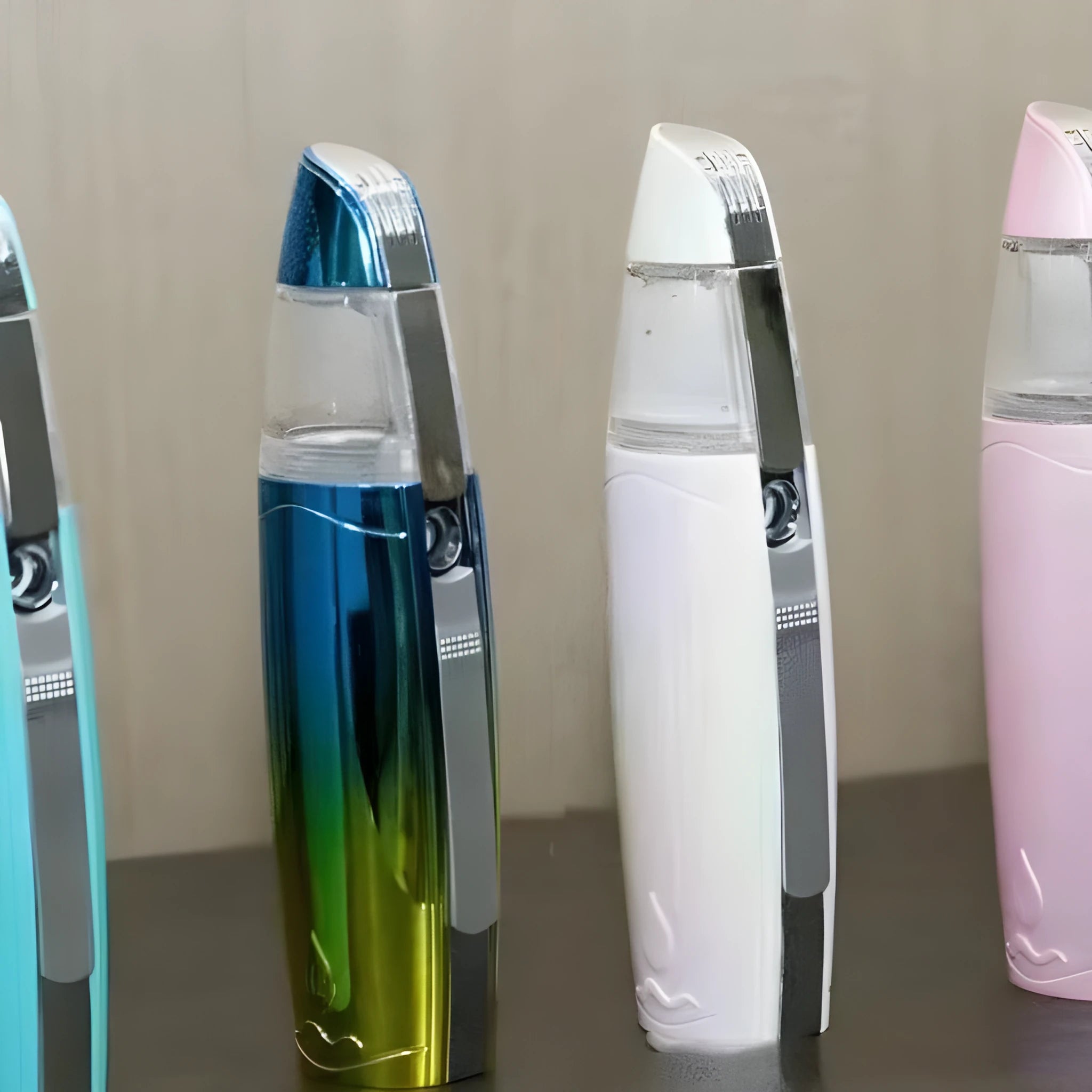 Peacock blue handheld facial steamer with USB charging port and mist spray nozzle