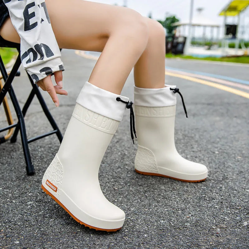 Women's solid-colour PVC rain boots with non-slip sole in apricot, black, brown, and pink
