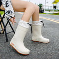 Women's solid-colour PVC rain boots with non-slip sole in apricot, black, brown, and pink