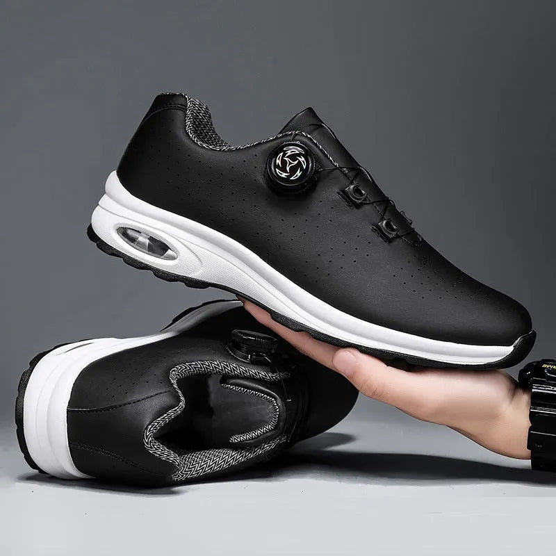 Low-top black and white casual tennis shoes with mesh upper and flat composite sole.