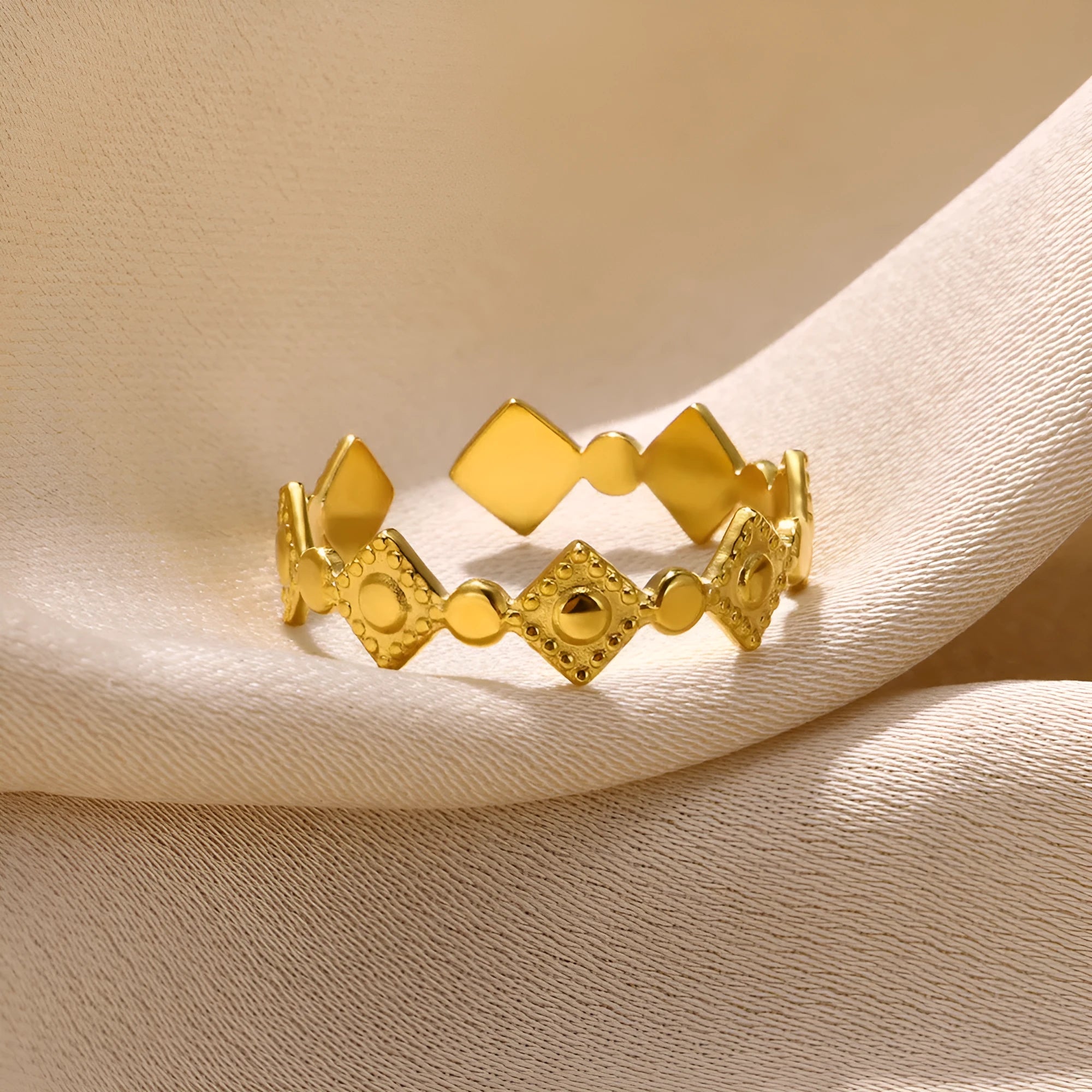 Gold geometric titanium steel women's ring with diamond accents on grey background