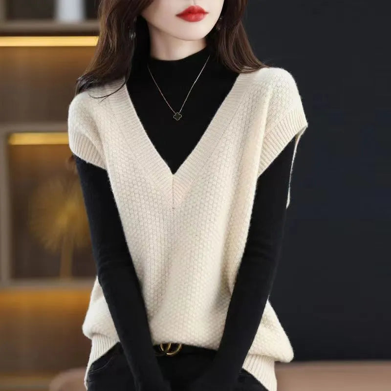 Women's creamy-white V-neck sleeveless vest with 3D pattern texture, folded to show detail.