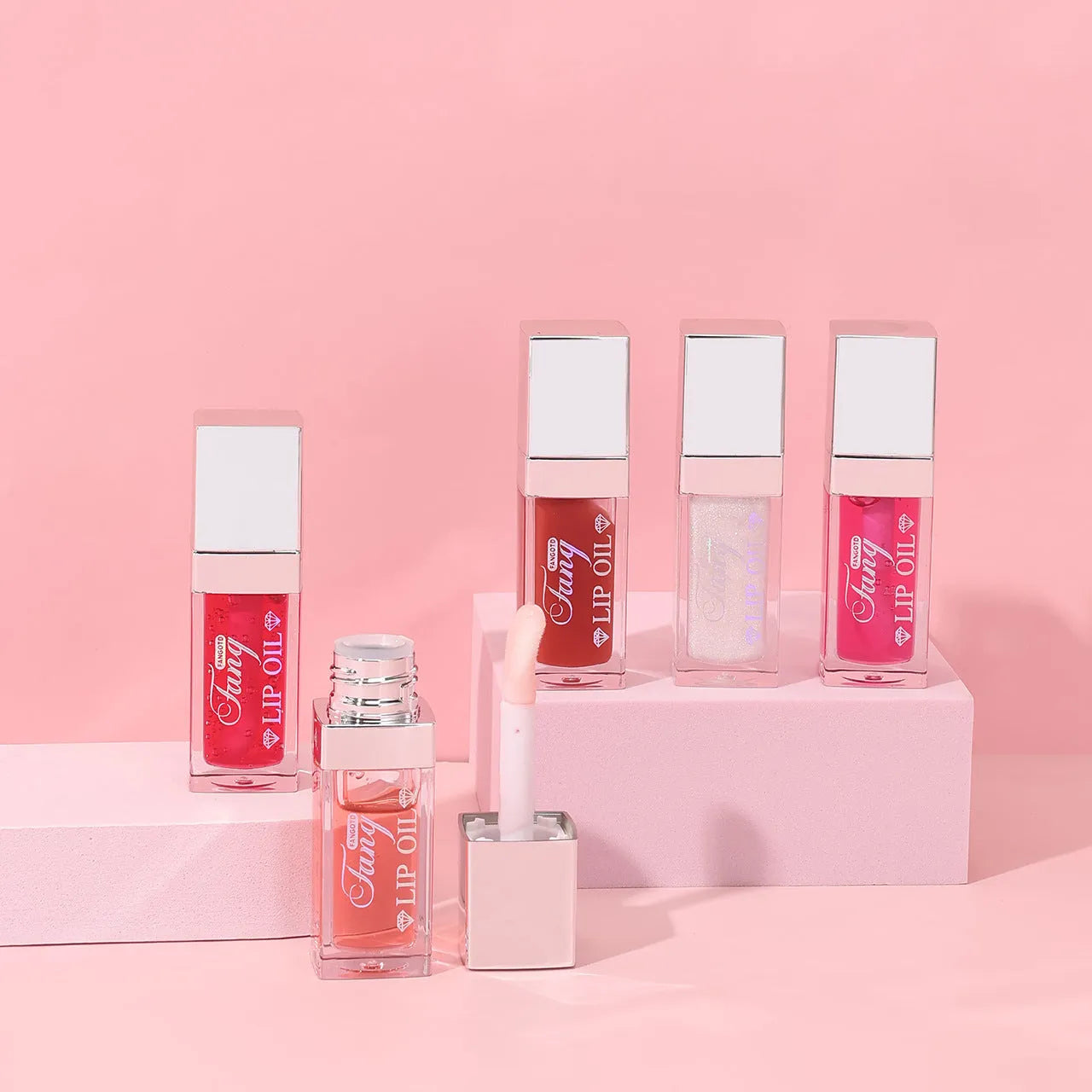Mint lip essence oil tube in one of five bright colours, shown as a dual-use lip gloss and lipstick.