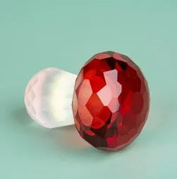 Colourful crystal mushroom decoration in modern geometric style on a white background.