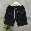 Men's black and white striped casual shorts with elastic waistband showing straight-leg design