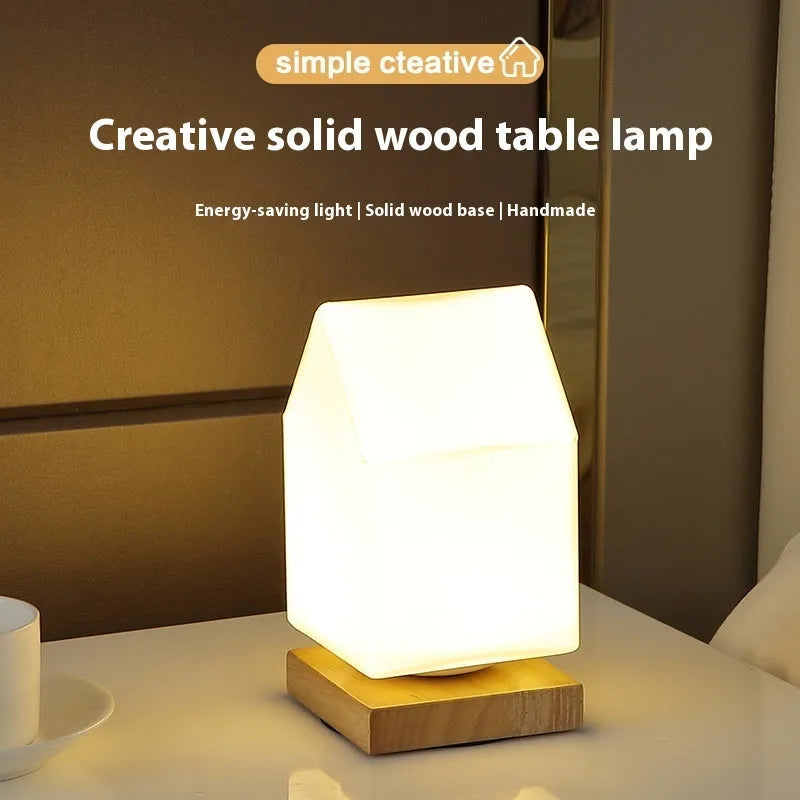 Nordic solid wood USB table lamp in a geometric shape on a wooden surface.