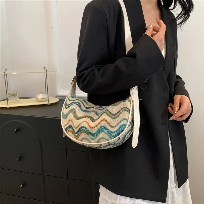 Women's straw woven crossbody bag showing woven texture and internal organisation with phone pocket