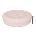 Portable dog bowl in light green colour shown on grass for outdoor feeding
