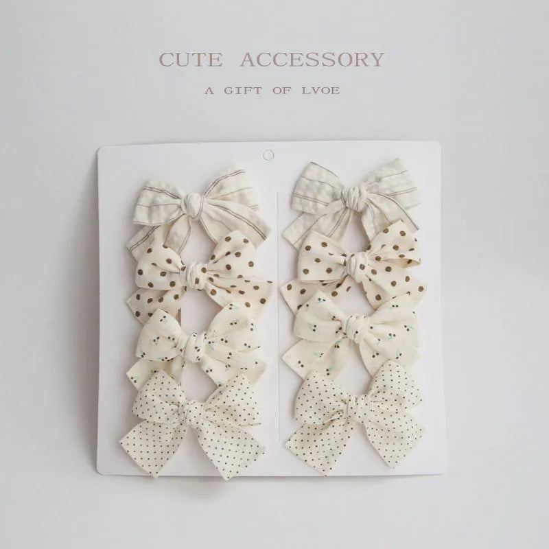 Children's dovetail bow hairclips in eight colour patterns including grid dots and floral designs