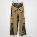 Dark khaki leopard print high waist straight leg denim trousers with contrast stitching detail.