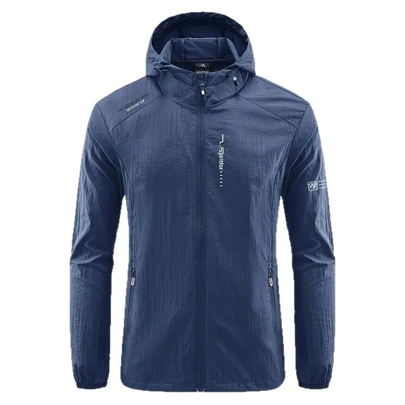 Man wearing a lightweight grey hooded nylon summer jacket outdoors.