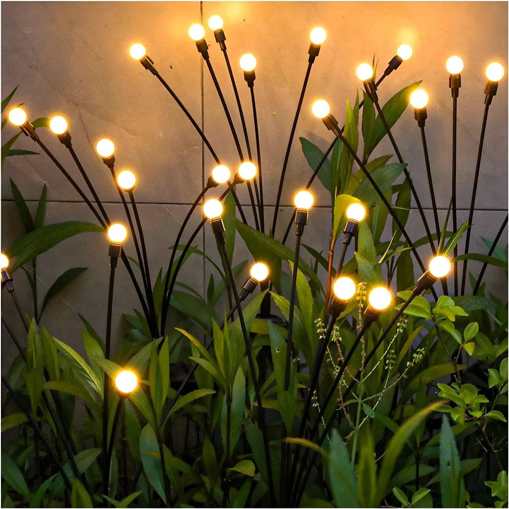 Solar-powered LED garden spike light with stainless steel ground plug stuck in soil.