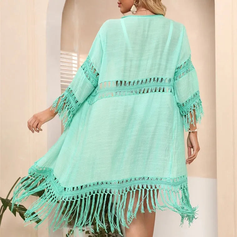 Hand-crocheted yellow beach cardigan cover-up with tassel detailing on mannequin