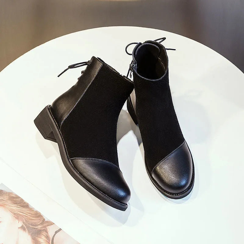 Women's black knee-high Martin boots with side zip and decorative bow detail