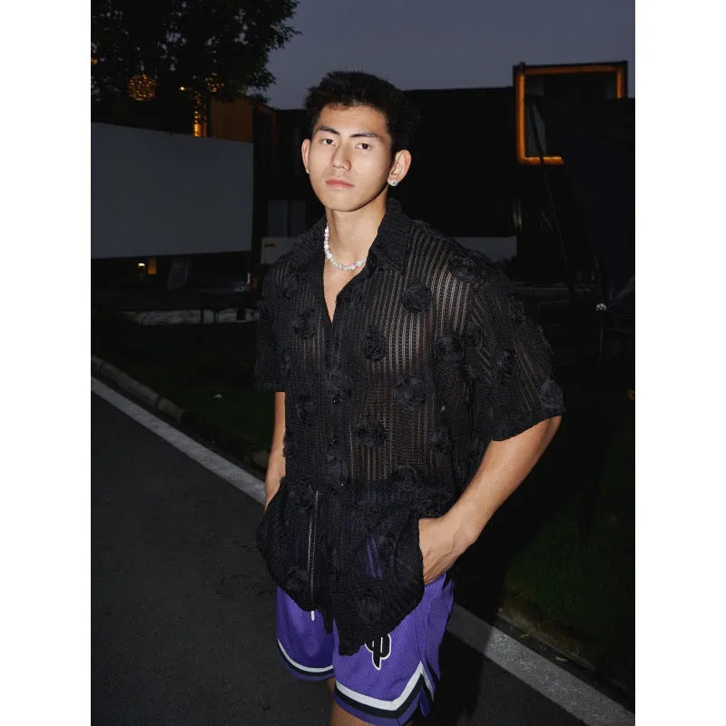 Man wearing a beige loose-fit short sleeve shirt with a textured three-dimensional floral print pattern.