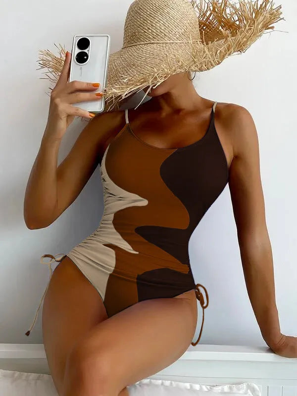 Women's blue sleeveless one-piece swimsuit with a striped pattern on a mannequin.