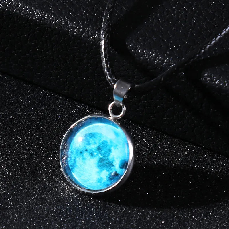 Luminous moon and constellation pendant necklace on a chain with an extension, shown in one of ten possible colours.