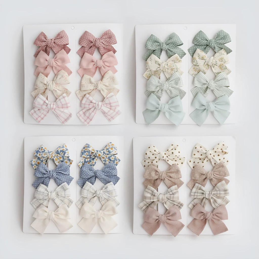 Children's dovetail bow hairclips in eight colour patterns including grid dots and floral designs