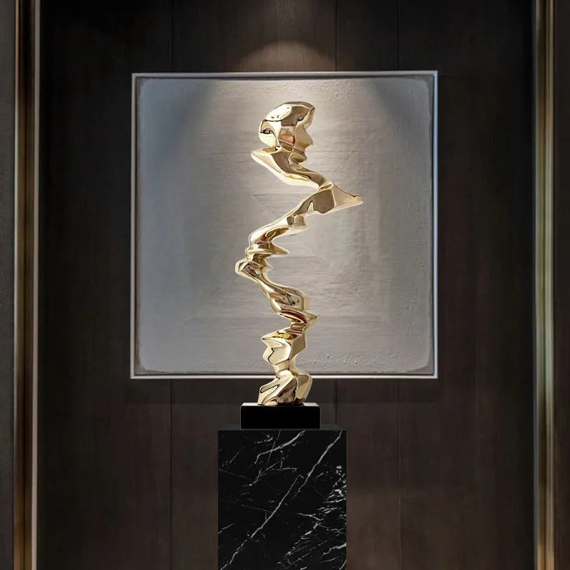 Modern abstract still life ornament in natural resin, shown in bright gold, elegant silver, and phantom blue finishes.