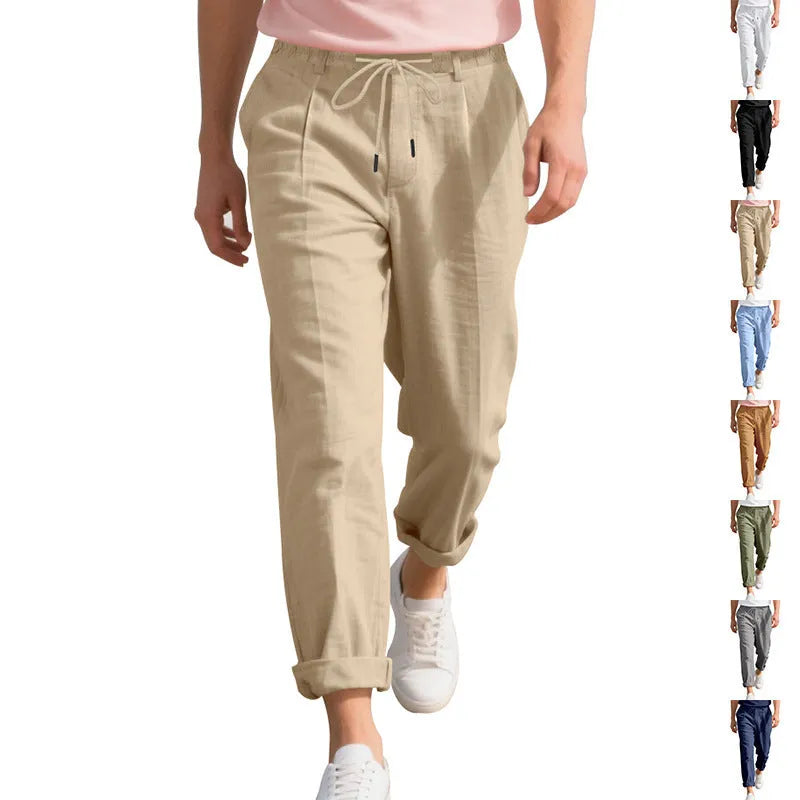 Men's light beige linen casual trousers with a drawstring waist and straight leg on a hanger.