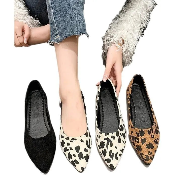Women's leopard print flat pointed toe pumps with low heel on a rubber sole.