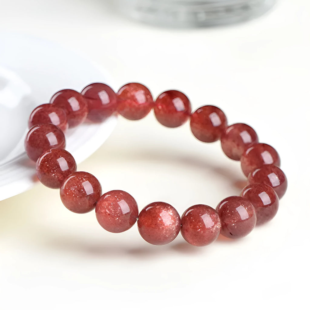 Natural strawberry quartz bracelet with geometric cherry red beads showing a starlight sparkle.