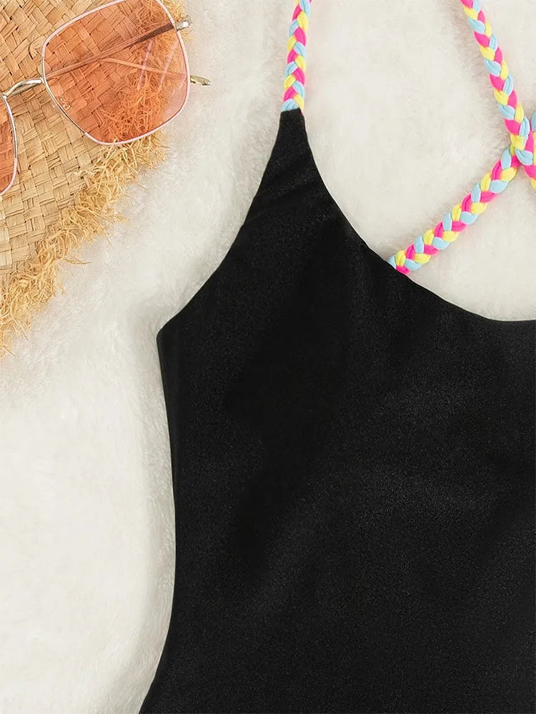 Black backless one-piece swimsuit on a white background