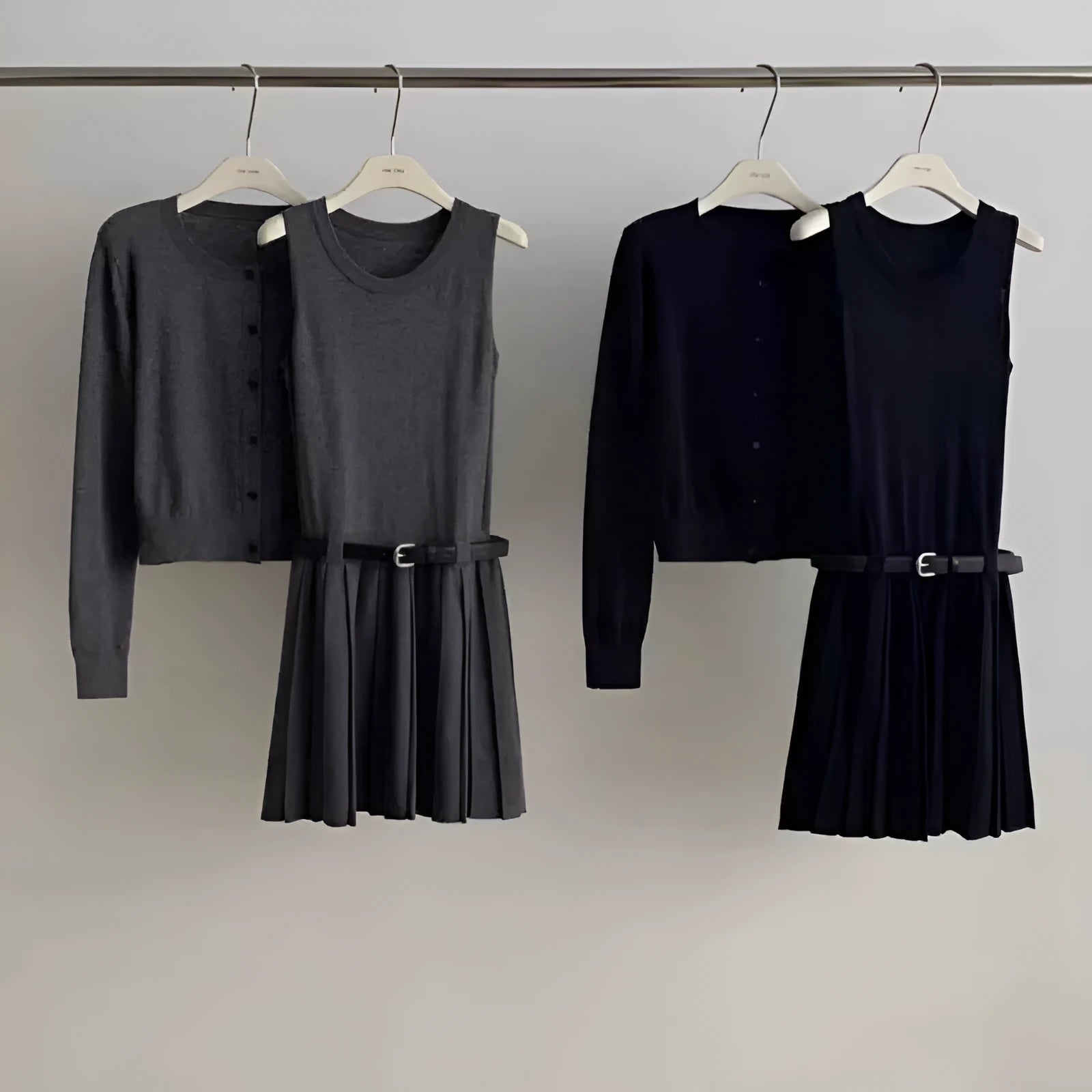 Women's black art retro knitted vest skirt and long sleeve cardigan two-piece set with belt.