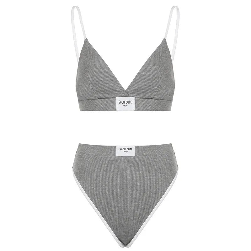 Women's embroidered black bikini set with contrast binding and shorts-length bottoms.