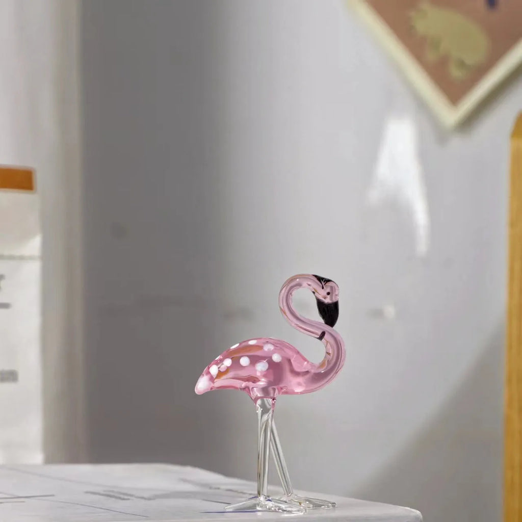Pink flamingo crystal animal decoration on a tabletop in separate and juxtaposition styles.