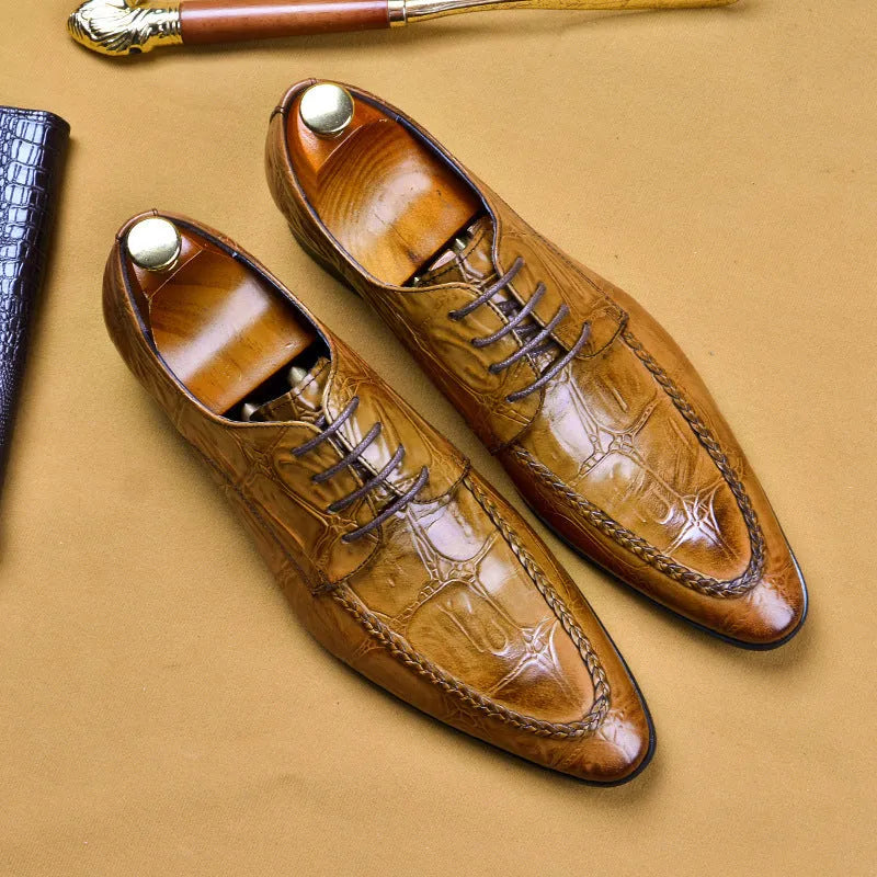 Black men's leather loafers with a silver horsebit buckle on a pointed toe, side view.