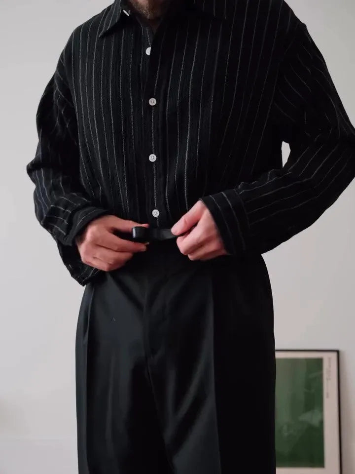Black pinstriped button-down shirt with regular fit on a hanger