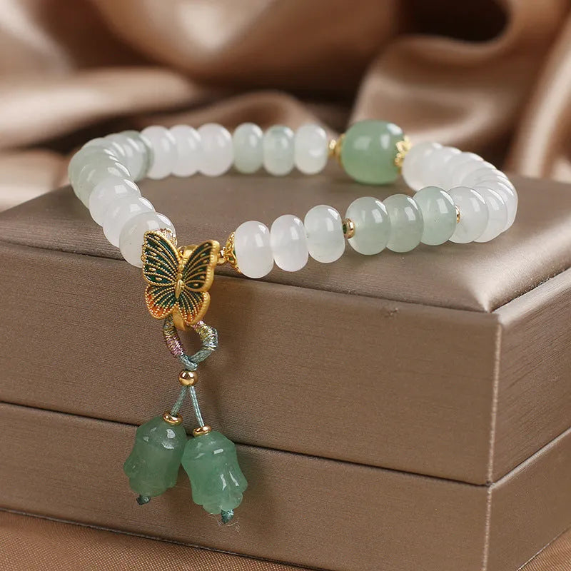 Green abacus bead bracelet for women with a butterfly tassel, pearls, and rhinestones